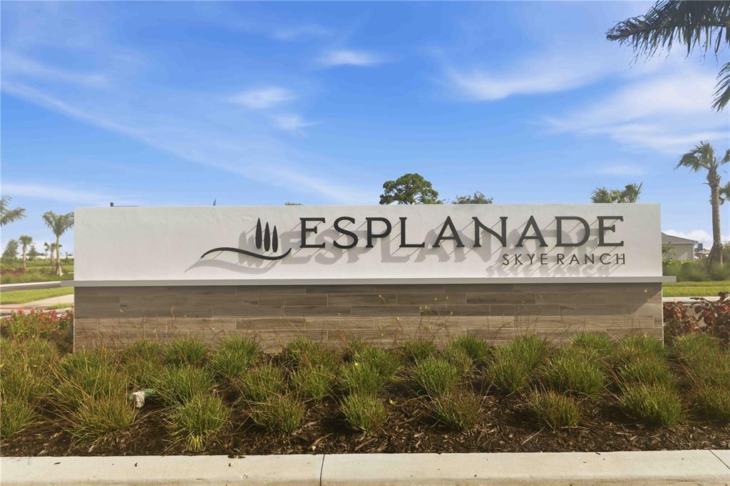 A single-story house with a paved driveway, a two-car garage, and palm trees — 7704 MOONBEAM AVENUE, SARASOTA, FL