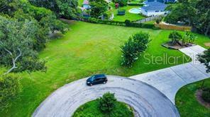 An aerial view shows a vacant grassy lot situated at the end of a cul-de-sac — 4638 LITTLE GROVE LANE, LAKELAND, FL