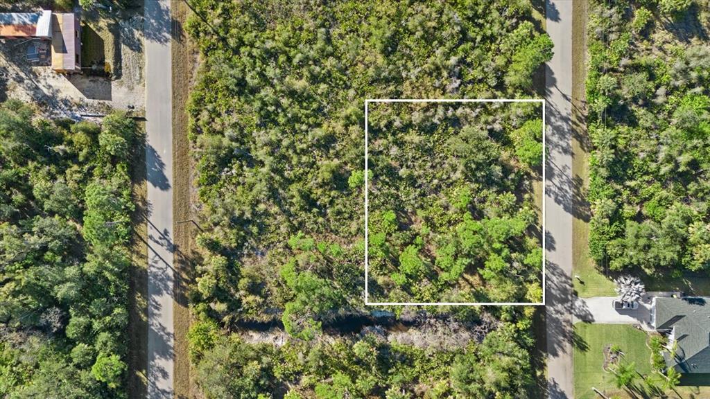 An aerial view shows a rectangular plot of land outlined in white between two roads — 14113 HYDRANGEA AVENUE, PORT CHARLOTTE, FL