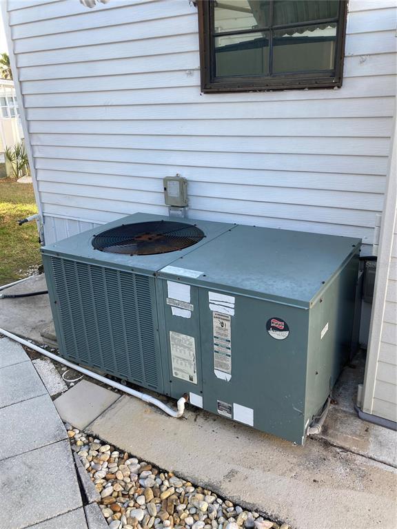 An outdoor HVAC unit sits on a concrete pad next to a white-sided building — 9000 US HIGHWAY 192 UNIT 729, CLERMONT, FL