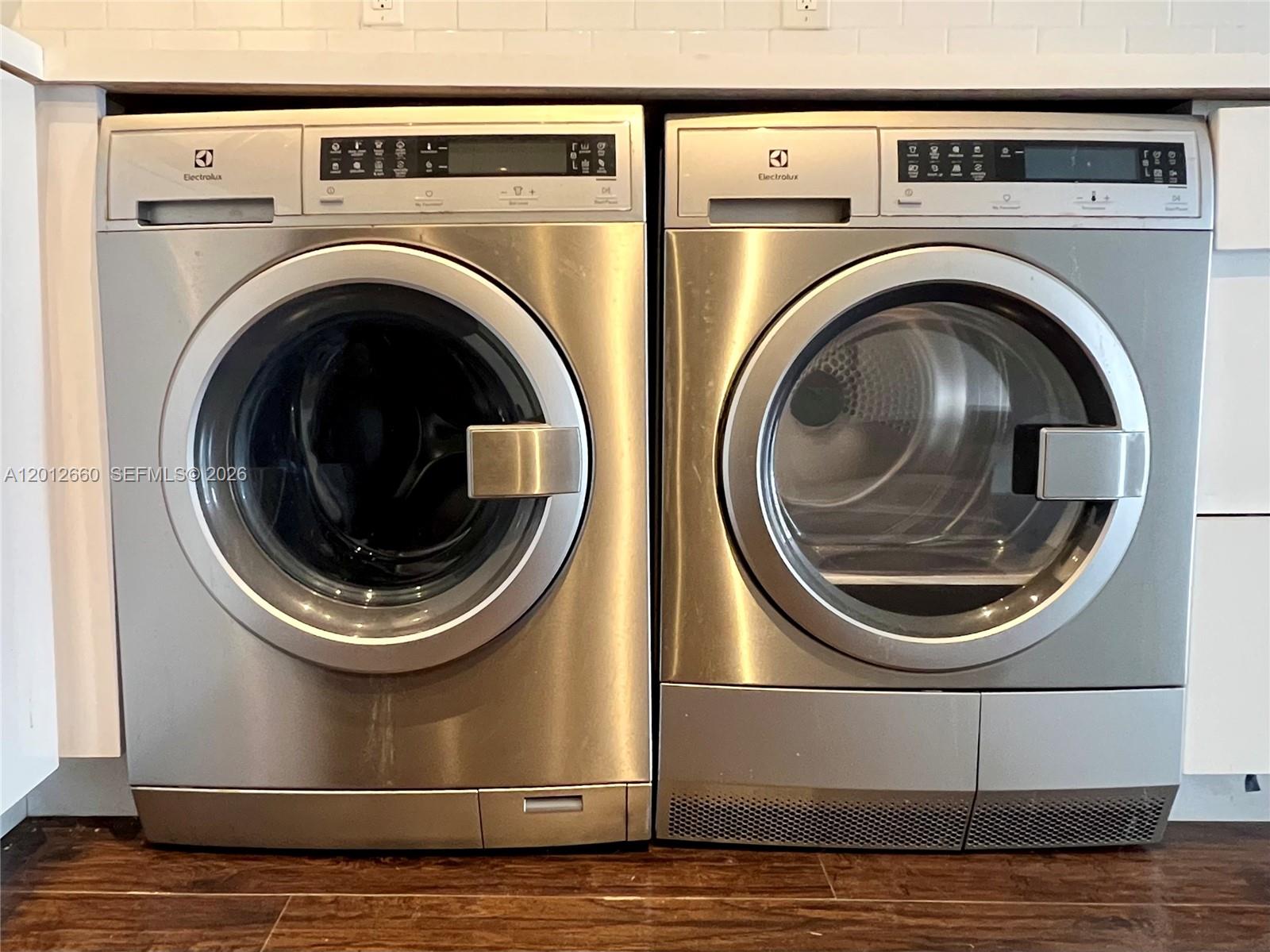 A stainless steel Electrolux washer and dryer set sit side-by-side under a white countertop — 5055 NW 7th St # 303, Miami FL 33126, MIAMI, FL