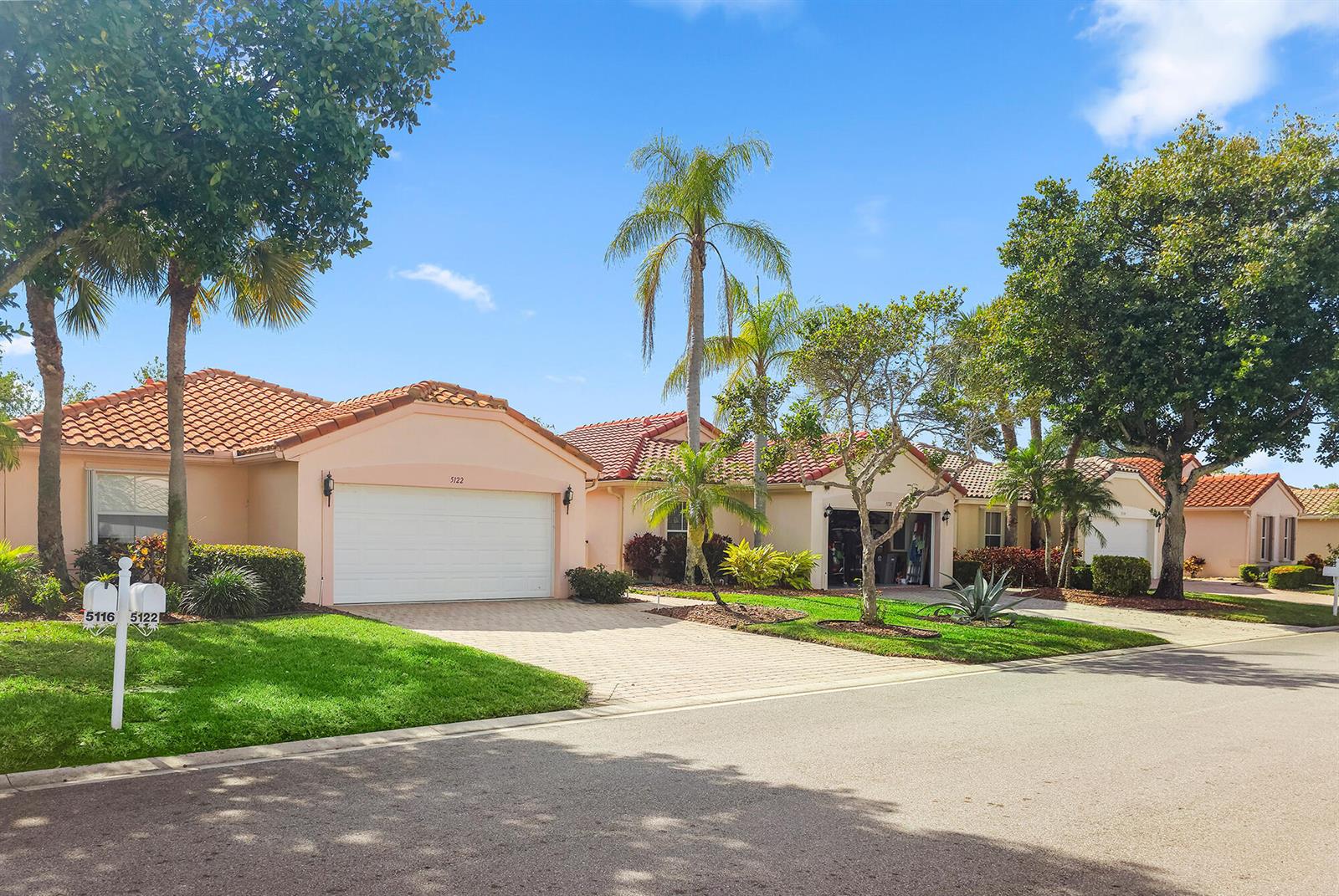 A row of single-story houses with peach-colored stucco walls and red tile roofs — 5122 Corbel Lake Way, Boynton Beach FL 33437, BOYNTON BEACH, FL