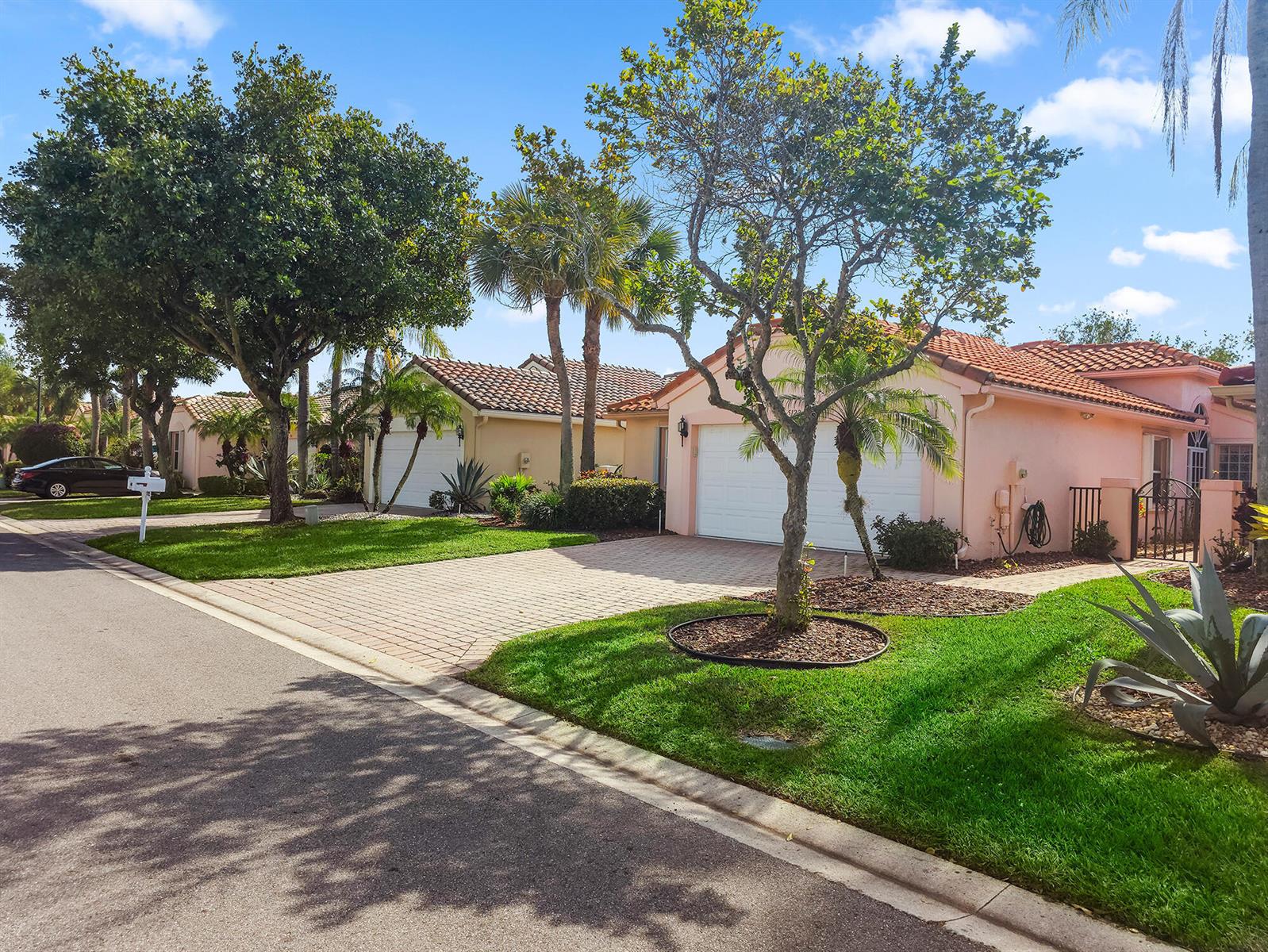 A street view of two single-story suburban homes with tiled roofs and paved driveways — 5122 Corbel Lake Way, Boynton Beach FL 33437, BOYNTON BEACH, FL