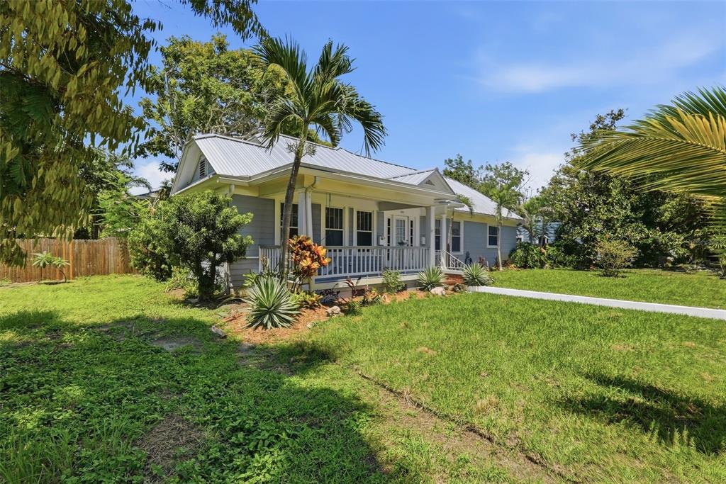A single-story house with a metal roof and front porch sits on a grassy lot — 4227 2ND AVENUE N, ST PETERSBURG, FL