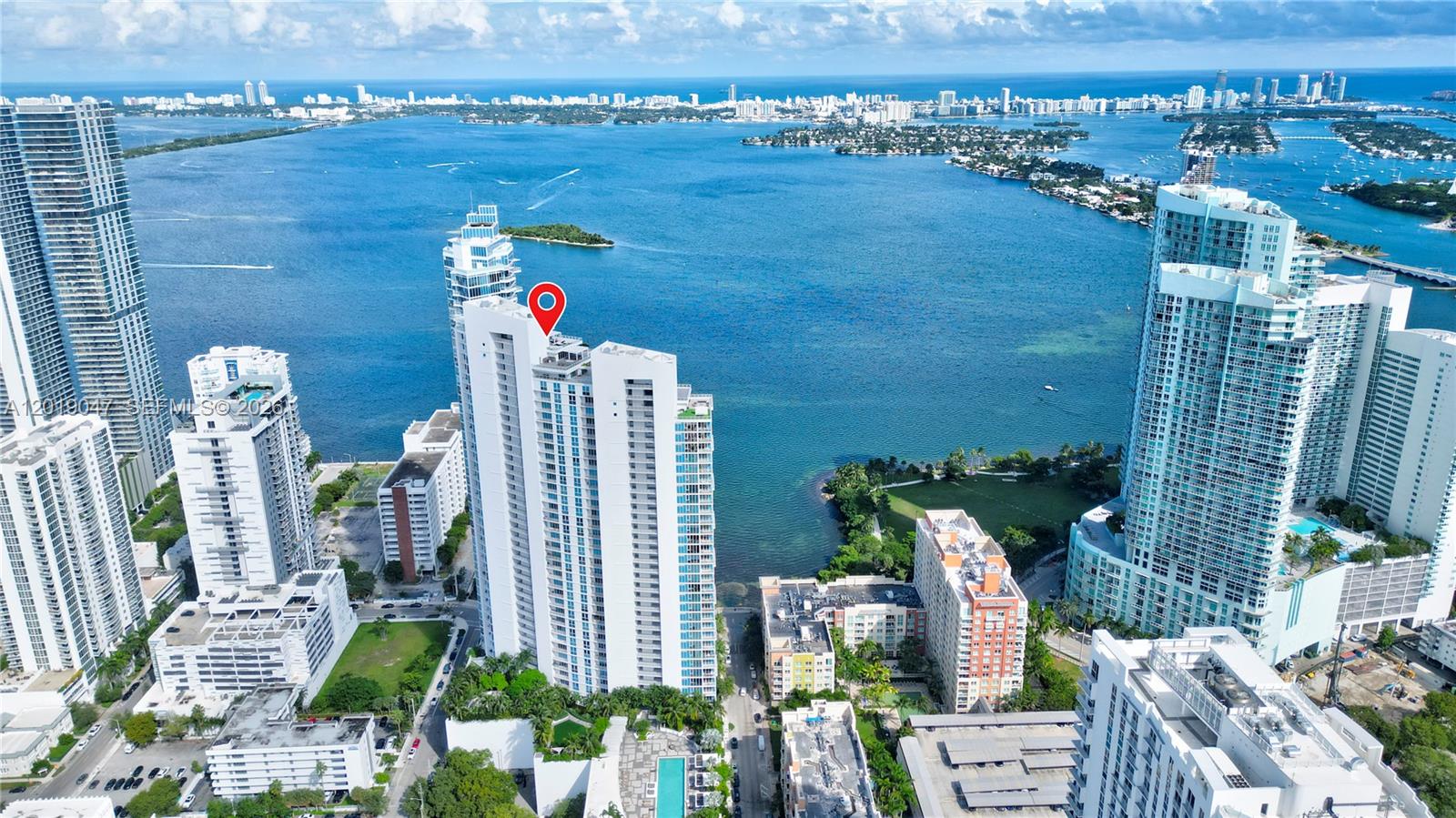 An aerial view shows a tall white residential building with a red location pin — 2020 N Bayshore Dr # 1905, Miami FL 33137, MIAMI, FL