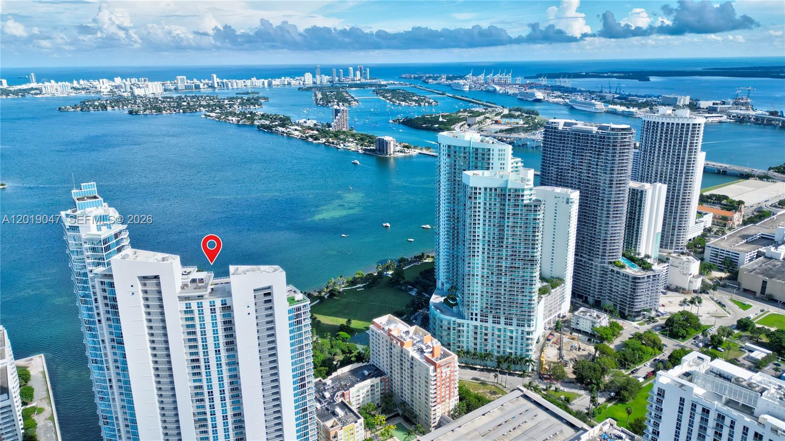 An aerial view shows high-rise residential buildings along a waterfront in a coastal city — 2020 N Bayshore Dr # 1905, Miami FL 33137, MIAMI, FL