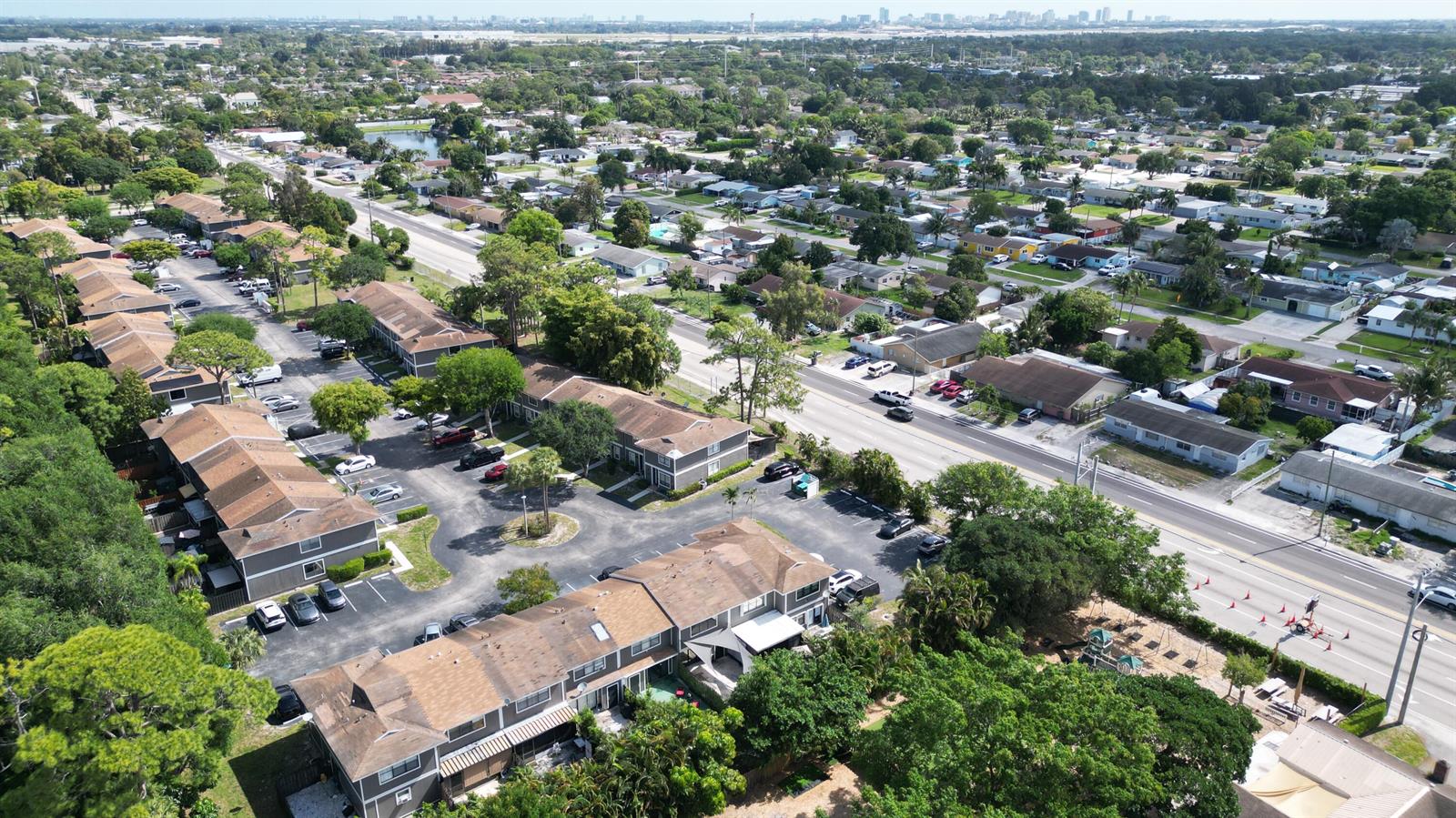 An aerial view shows multi-unit residential buildings with parking lots and surrounding suburban neighborhoods — 850 Hill Drive # D, West Palm Beach FL 33415, WEST PALM BEACH, FL