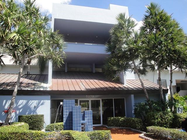 A multi-story building features a blue facade, a metal roof, and a tiled water feature — 5279 ISLA KEY BLVD UNIT 217, ST PETERSBURG, FL