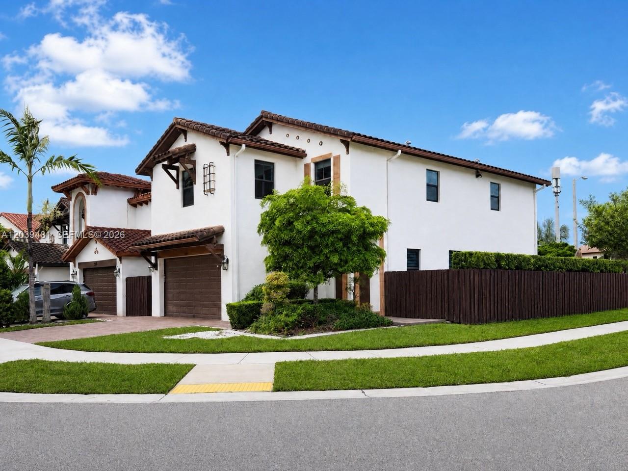 A two-story white stucco house with a brown tile roof and an attached two-car garage — 8605 NW 102nd Ct, Doral FL 33178, DORAL, FL