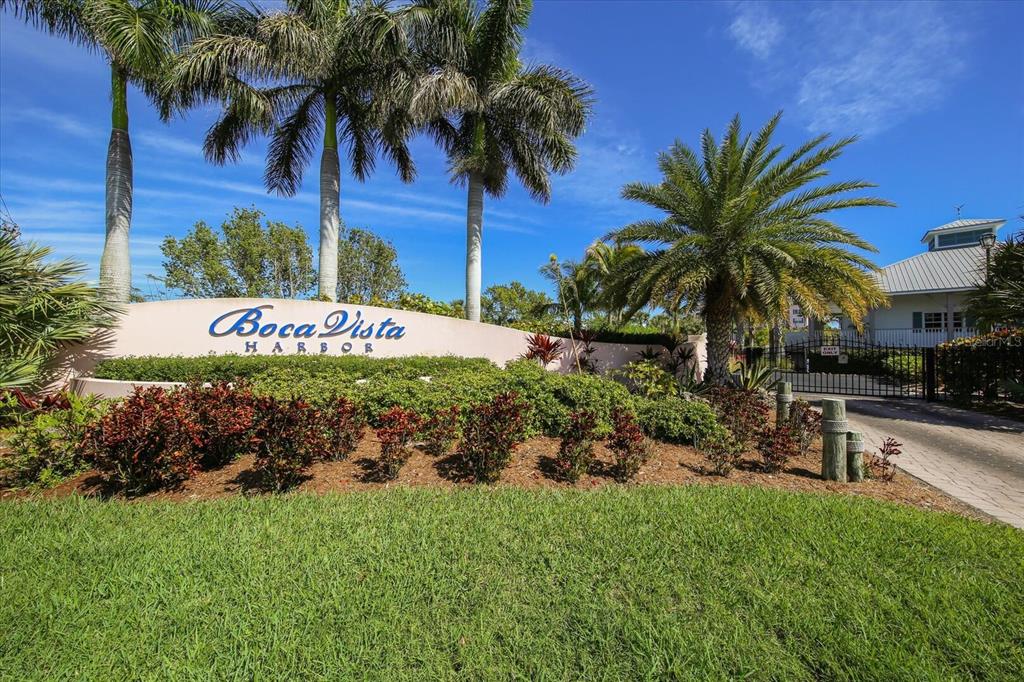 A landscaped entrance sign for Boca Vista Harbor features palm trees and a gated driveway — 13113 GASPARILLA ROAD UNIT 405, PLACIDA, FL