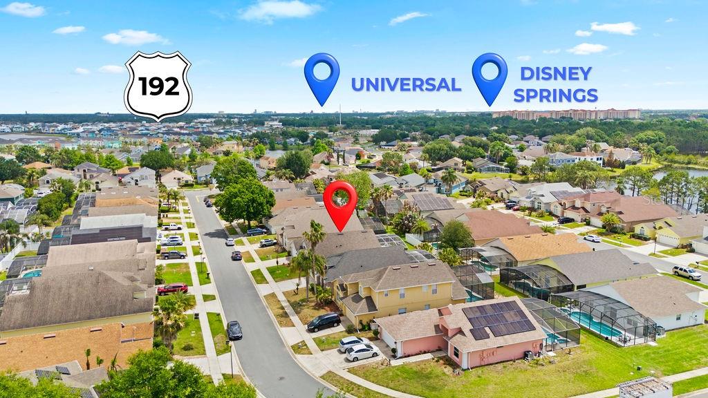 This aerial view shows a suburban neighborhood with a red location pin on a house — 2916 BLOOMING ALAMANDA LOOP, KISSIMMEE, FL