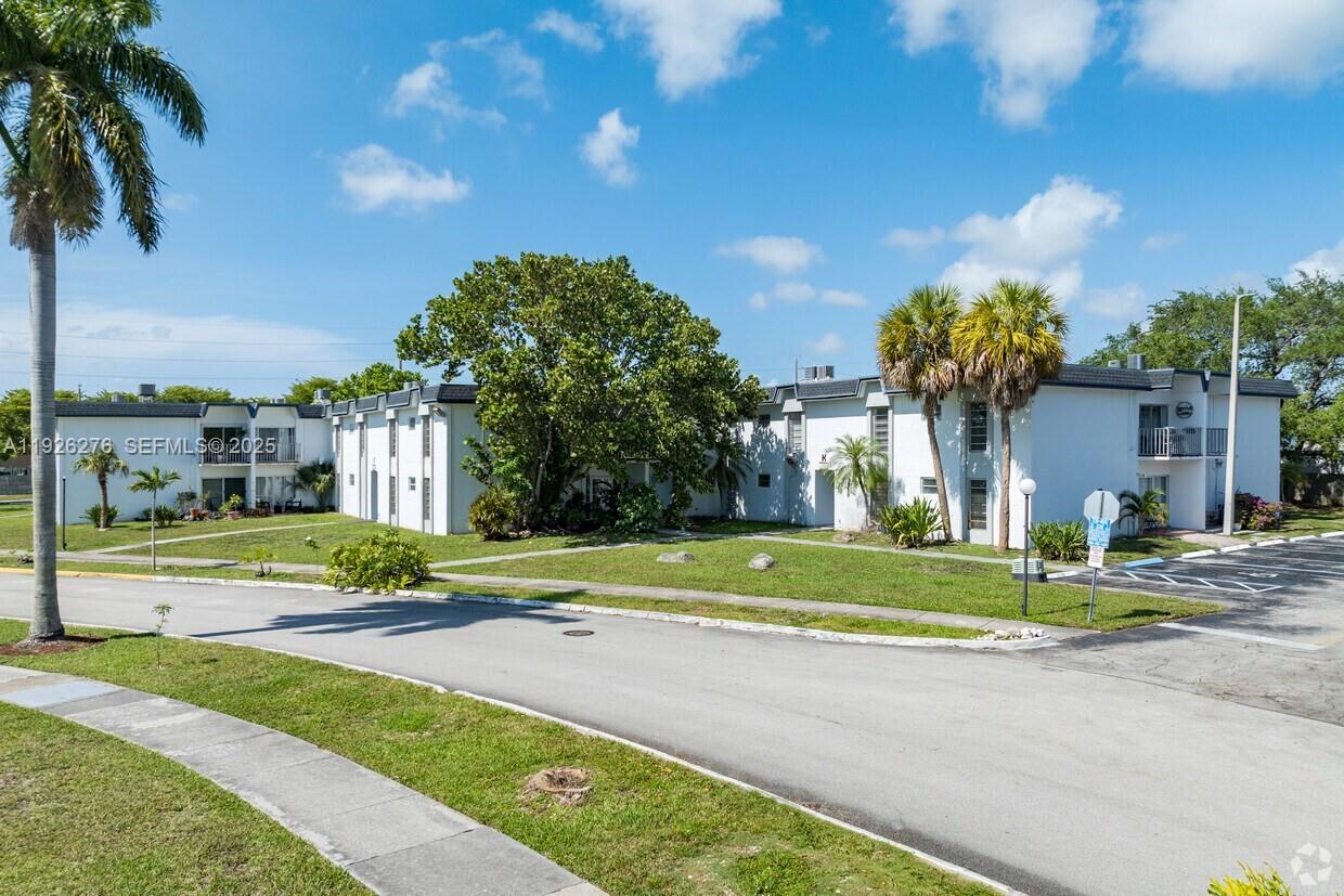A two-story white apartment building with palm trees and a paved parking area — 7250 SW 94th Pl # B6, Miami FL 33173, MIAMI, FL