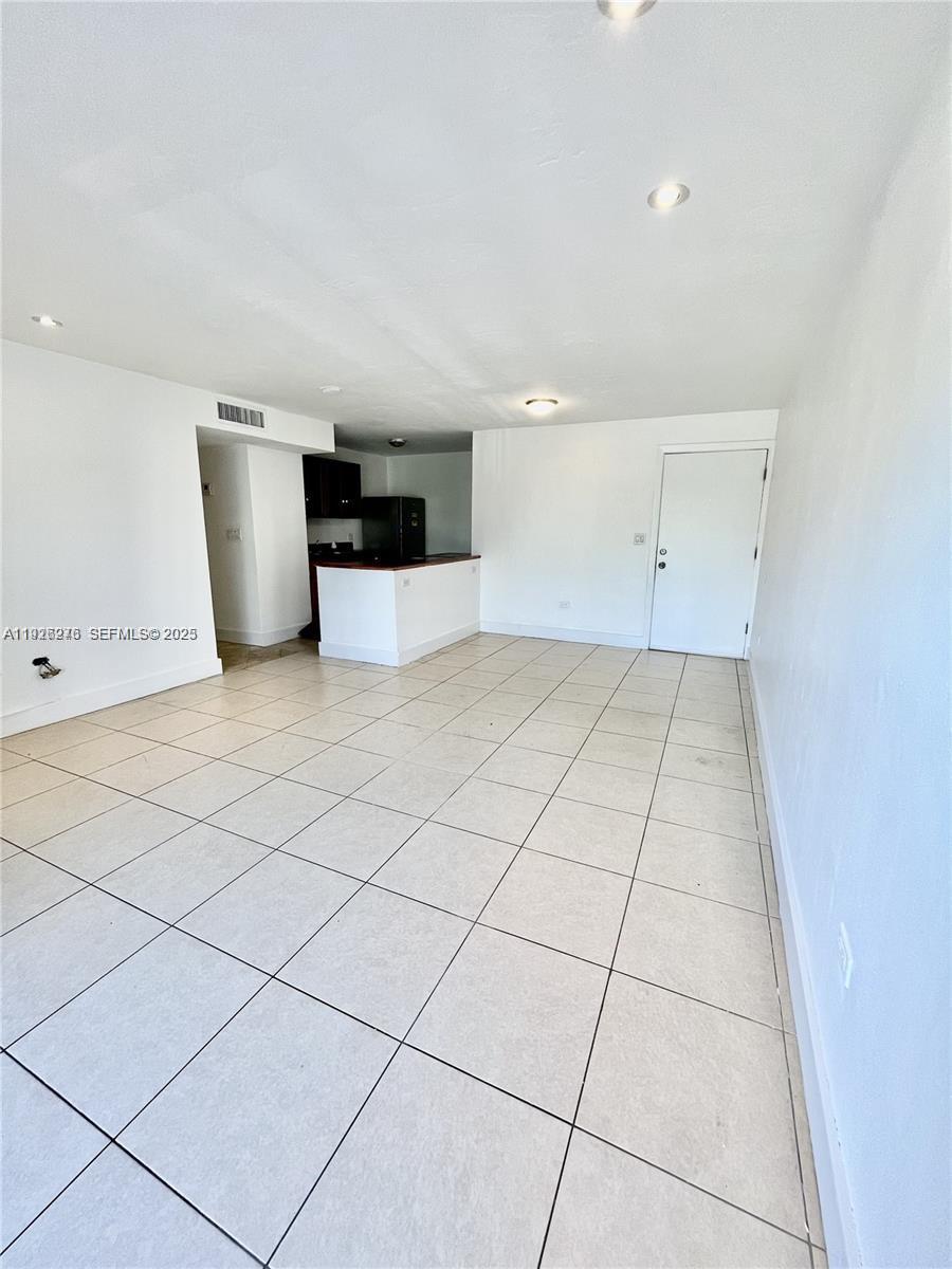 This room features white tile flooring, recessed lighting, and an open kitchen with dark cabinets — 7250 SW 94th Pl # B6, Miami FL 33173, MIAMI, FL