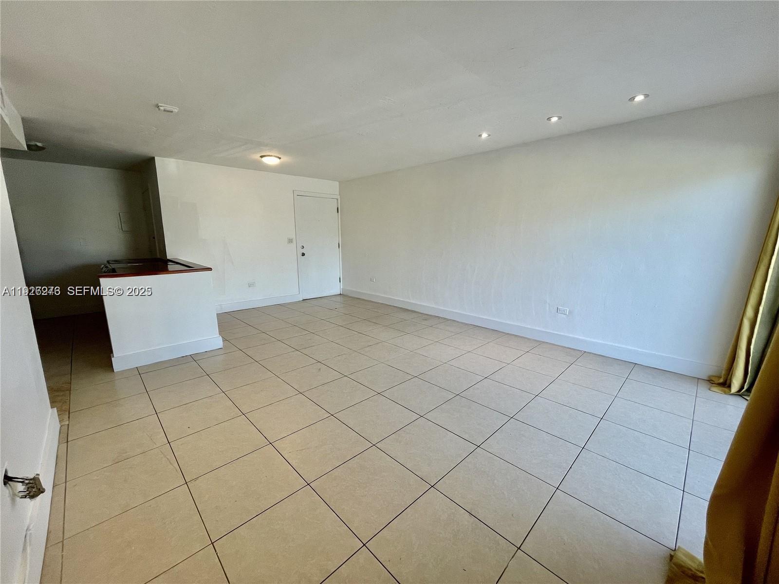 An empty room features white walls, beige tile flooring, and recessed ceiling lighting — 7250 SW 94th Pl # B6, Miami FL 33173, MIAMI, FL
