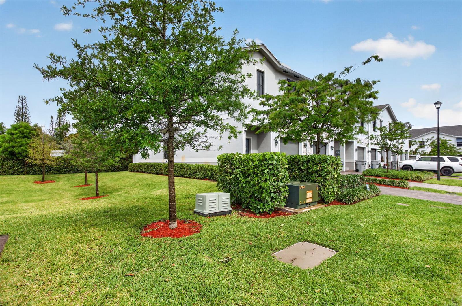 A view of the side of a multi-unit residential building with a grassy lawn — 873 NW 3rd Way, Pompano Beach FL 33060, POMPANO BEACH, FL