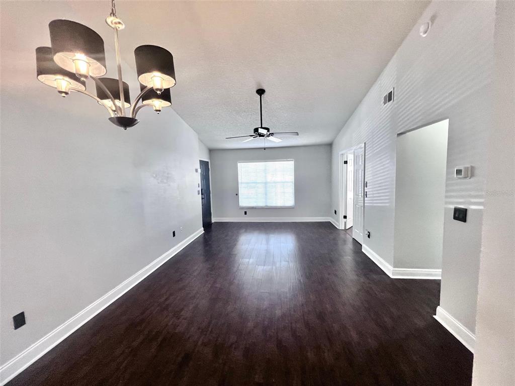 The exterior of a multi-story apartment building features a grassy lawn and screened-in porches — 7828 HARDWICK DRIVE UNIT 927, NEW PORT RICHEY, FL