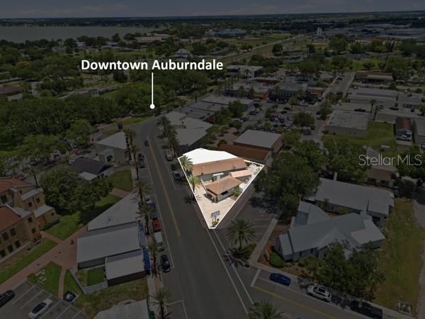 This aerial view shows a commercial building highlighted on a corner lot in downtown Auburndale — 119 MAIN STREET, AUBURNDALE, FL