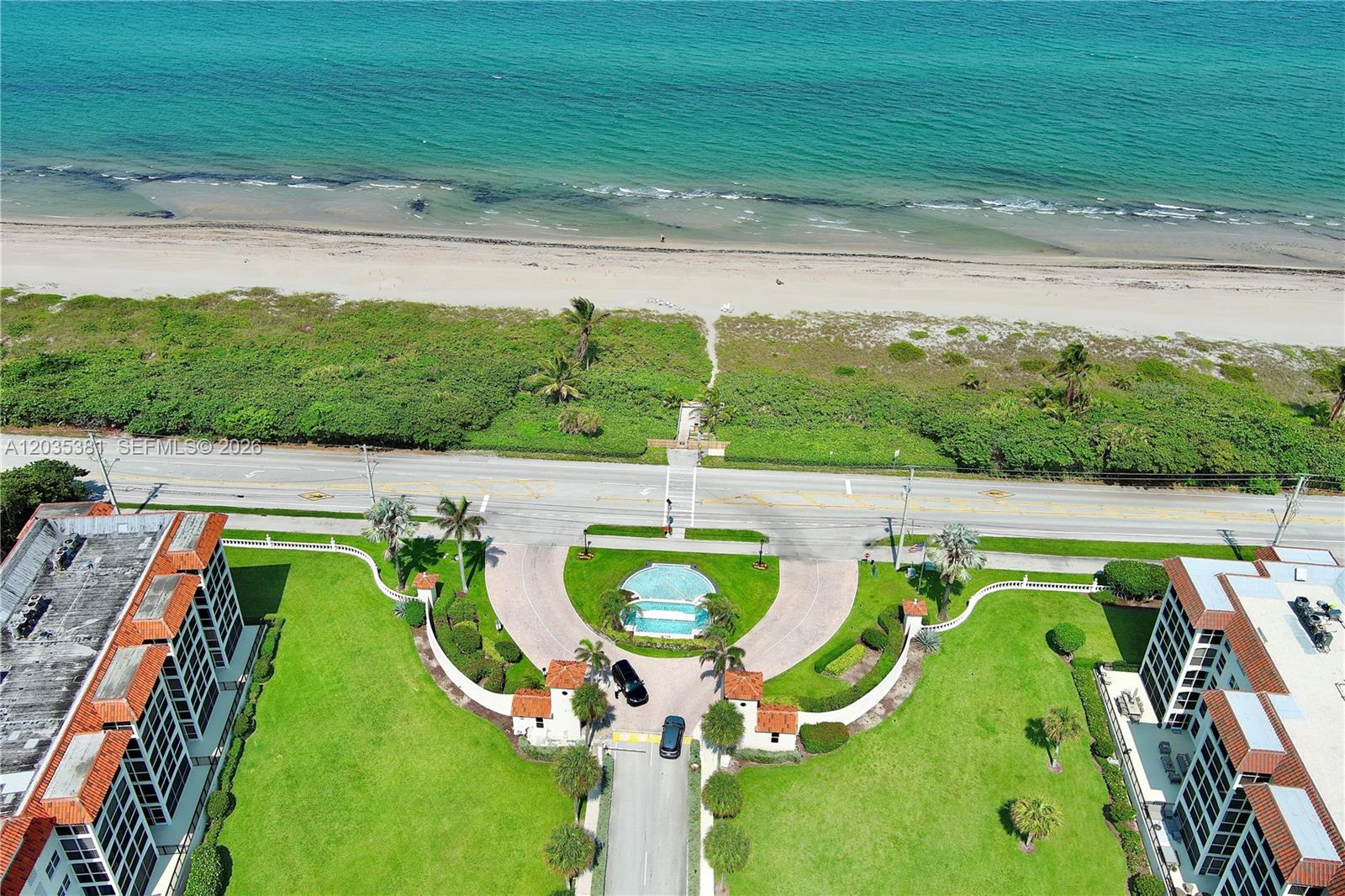 An aerial view shows a gated residential complex with a circular driveway facing the ocean — 2871 N Ocean Blvd # M126, Boca Raton FL 33431, BOCA RATON, FL