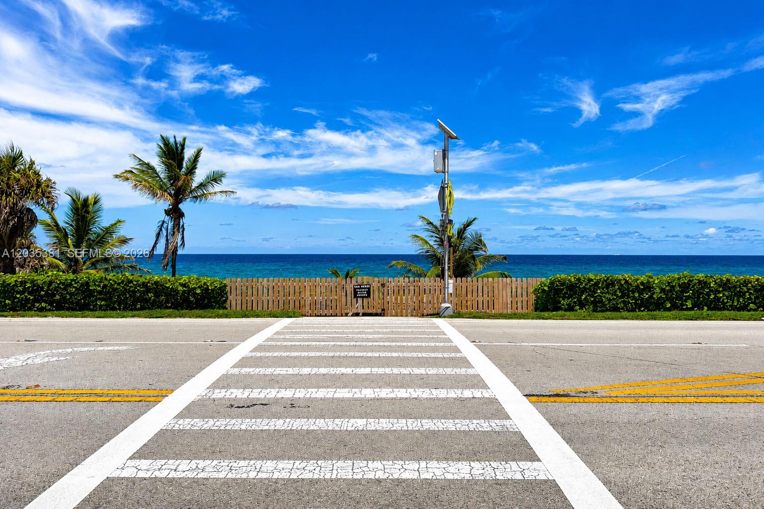 A crosswalk leads to a wooden fence and palm trees overlooking the ocean — 2871 N Ocean Blvd # M126, Boca Raton FL 33431, BOCA RATON, FL