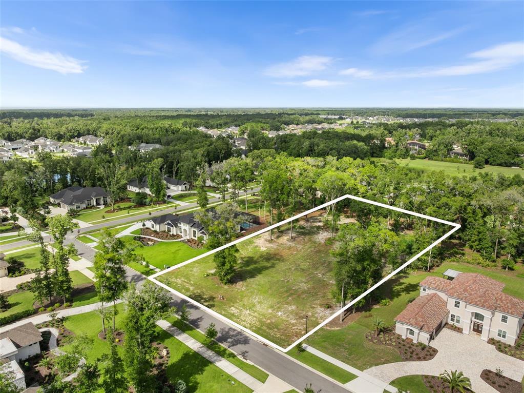 An aerial view shows a vacant, rectangular residential lot outlined in white within a neighborhood — 3120 SW 108TH WAY, GAINESVILLE, FL