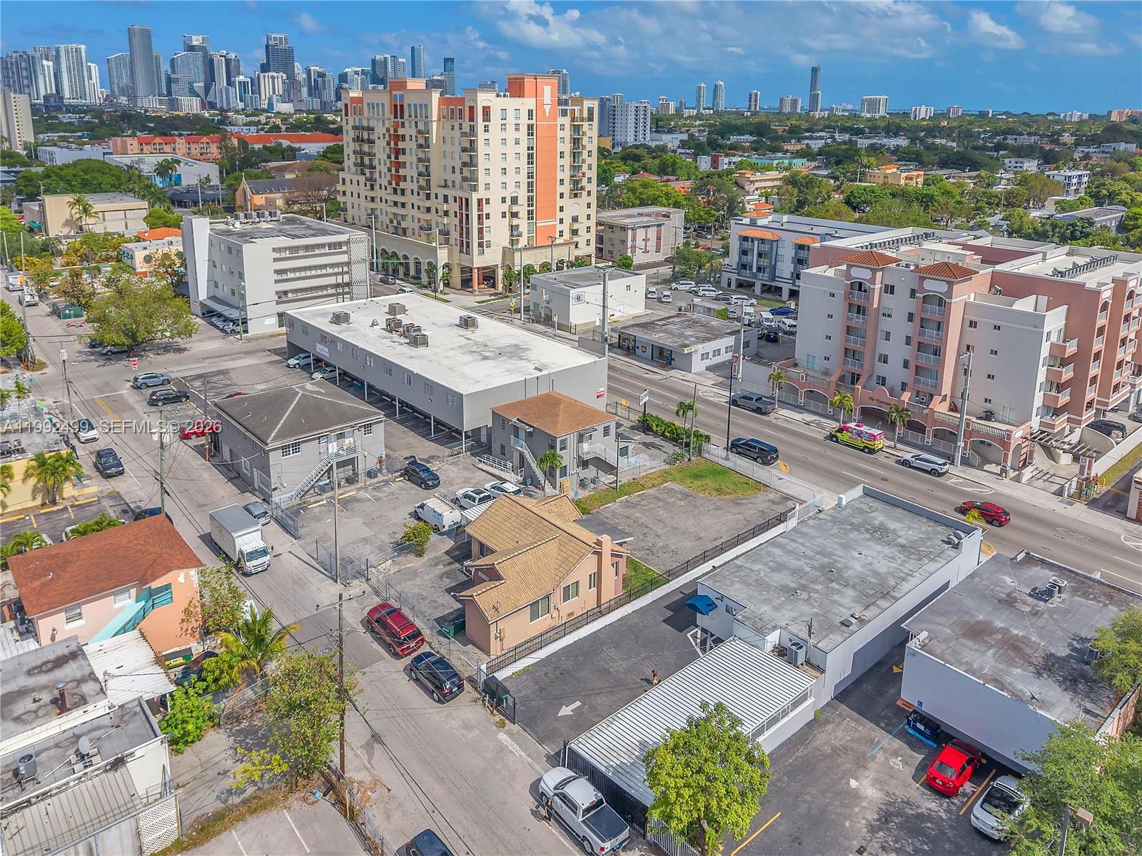 An aerial view shows a city neighborhood with various commercial buildings, parking lots, and streets — 1437 SW 1st St, Miami FL 33135, MIAMI, FL