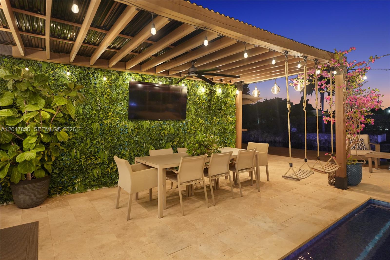 An outdoor patio features a dining set, a green wall, and swings under a pergola — 5241 SW 104th Ave, Miami FL 33165, MIAMI, FL