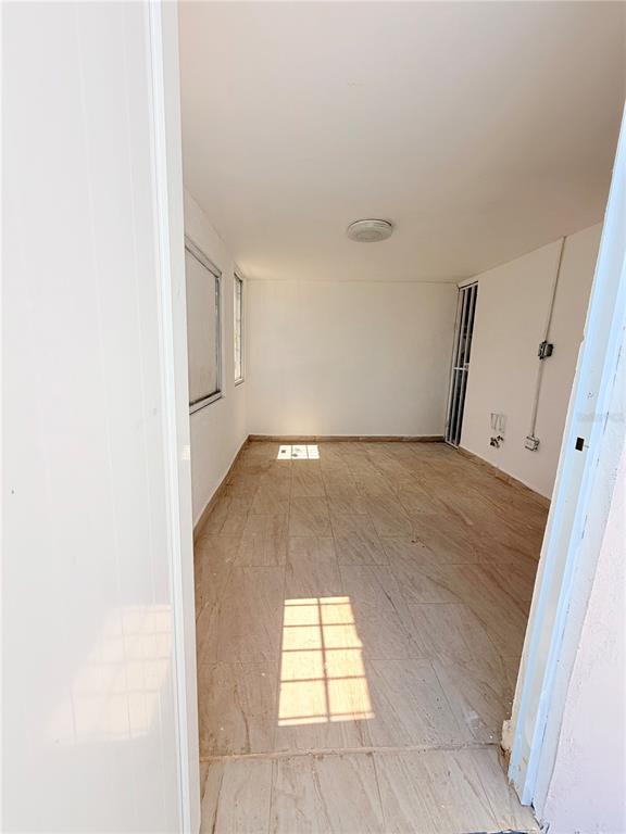An empty room with light-colored tile flooring, white walls, and a single ceiling light fixture — Calle 601 BLOQUE 224 COMERCIAL 3, CAROLINA, PR