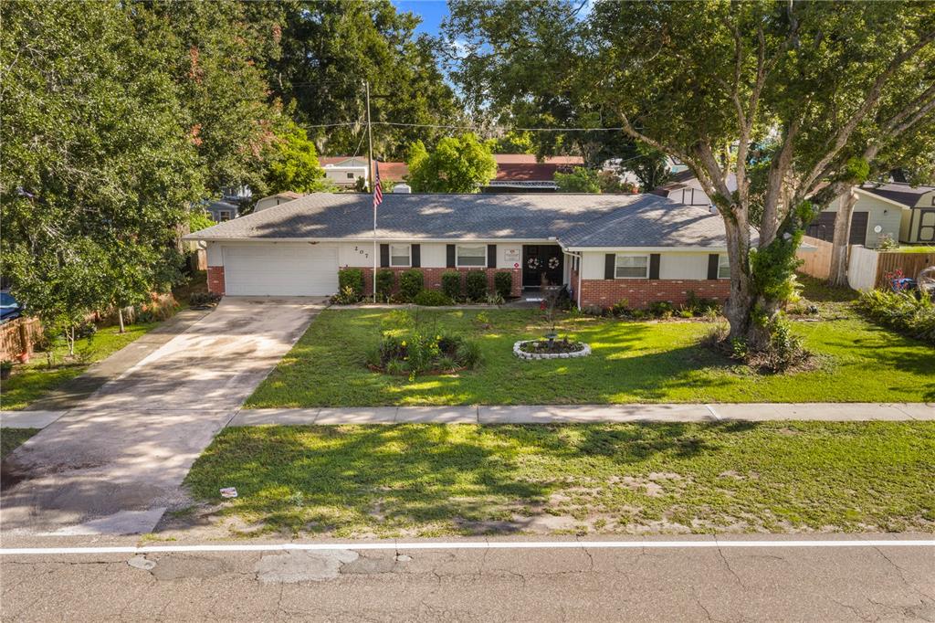 A single-story brick house with a two-car garage and a large front yard — 207 W WHEELER ROAD, SEFFNER, FL