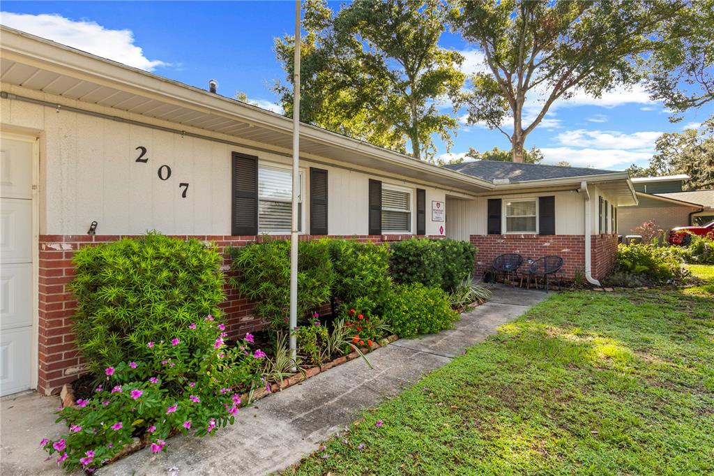 A single-story house with a brick and stucco exterior, a walkway, and a front lawn — 207 W WHEELER ROAD, SEFFNER, FL