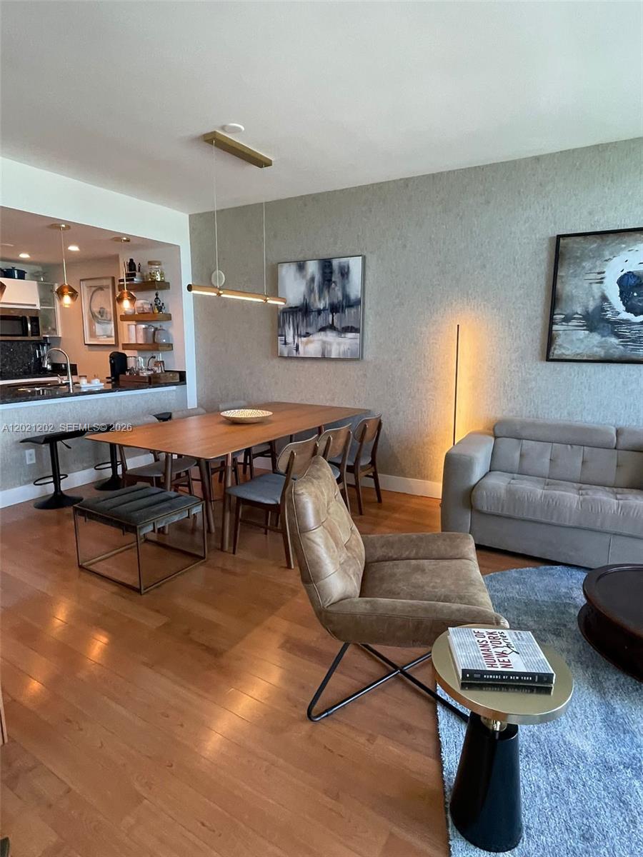 A bedroom features a bed with white bedding, a dark headboard, and floor-to-ceiling windows — 601 NE 36th St # 1805, Miami FL 33137, MIAMI, FL