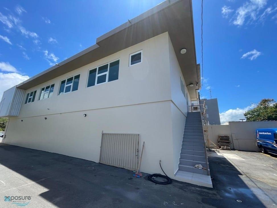 An exterior view of a two-story building with a staircase leading to the upper level — 57 PR2 KM57, BARCELONETA, PR