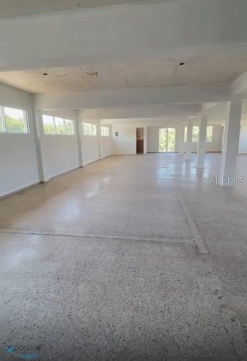 An open, unfinished interior space features white walls, concrete floors, and multiple support columns — 57 PR2 KM57, BARCELONETA, PR