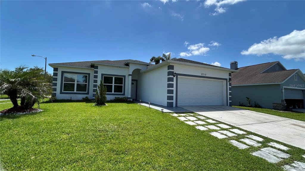 The exterior of the Remington Golf Club building features a sign, lawn, and parking area — 2713 WORTHAM LANE, KISSIMMEE, FL