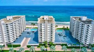 Three white multi-story apartment buildings stand along a sandy beach next to the ocean — 3221 S Ocean Boulevard # 1003, Highland Beach FL 33487, HIGHLAND BEACH, FL