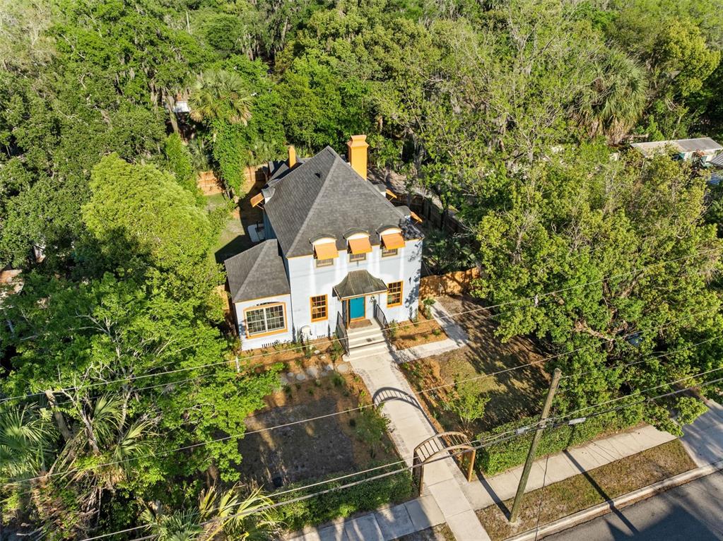 An aerial view of a two-story house with a dark roof and orange window awnings — 521 NE 6TH STREET, GAINESVILLE, FL