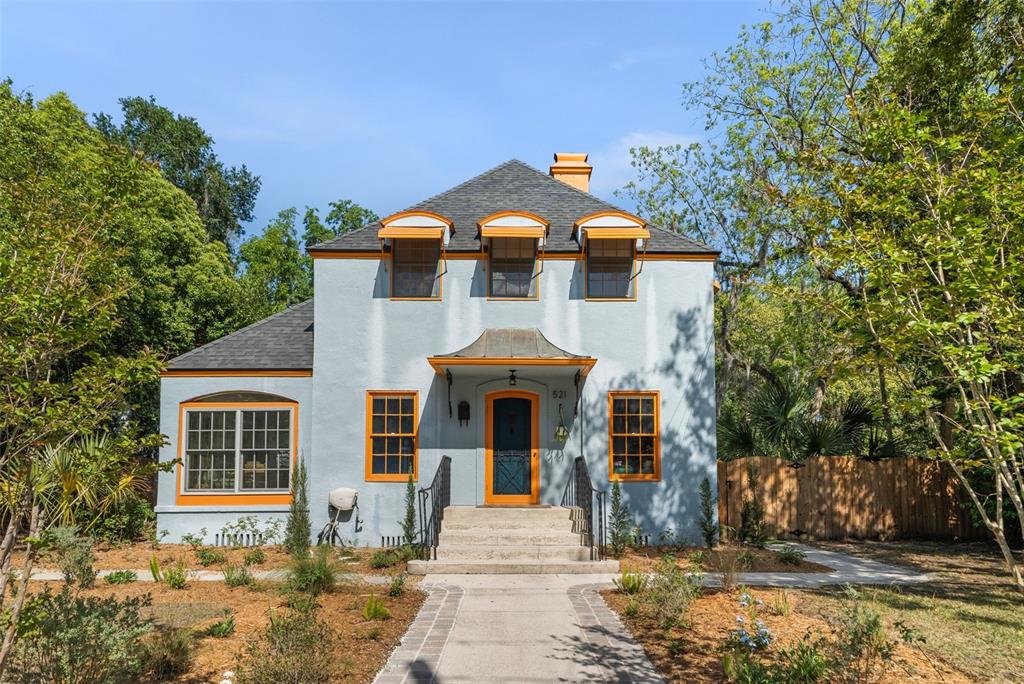 A two-story light blue house with orange trim and a front walkway — 521 NE 6TH STREET, GAINESVILLE, FL