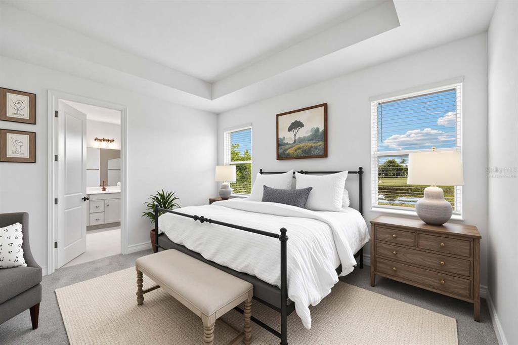 A bedroom features a metal bed frame, a wooden dresser, and an attached bathroom — 9669 CRYSTAL ISLES CIRCLE, SARASOTA, FL