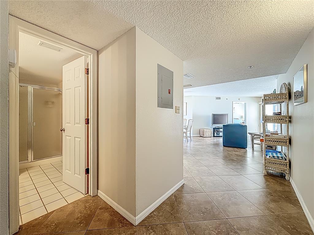 A tiled hallway leads to a living area with a bathroom door on the left — 18450 GULF BOULEVARD UNIT 401, INDIAN SHORES, FL