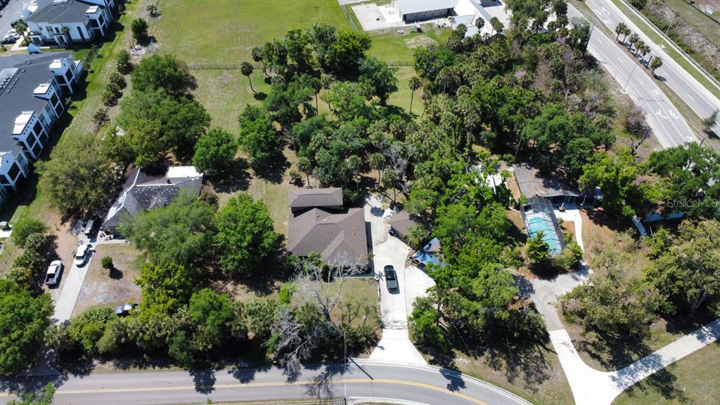 An aerial view shows a residential property with multiple houses, mature trees, and paved driveways — 6480 RICHARDSON ROAD, SARASOTA, FL