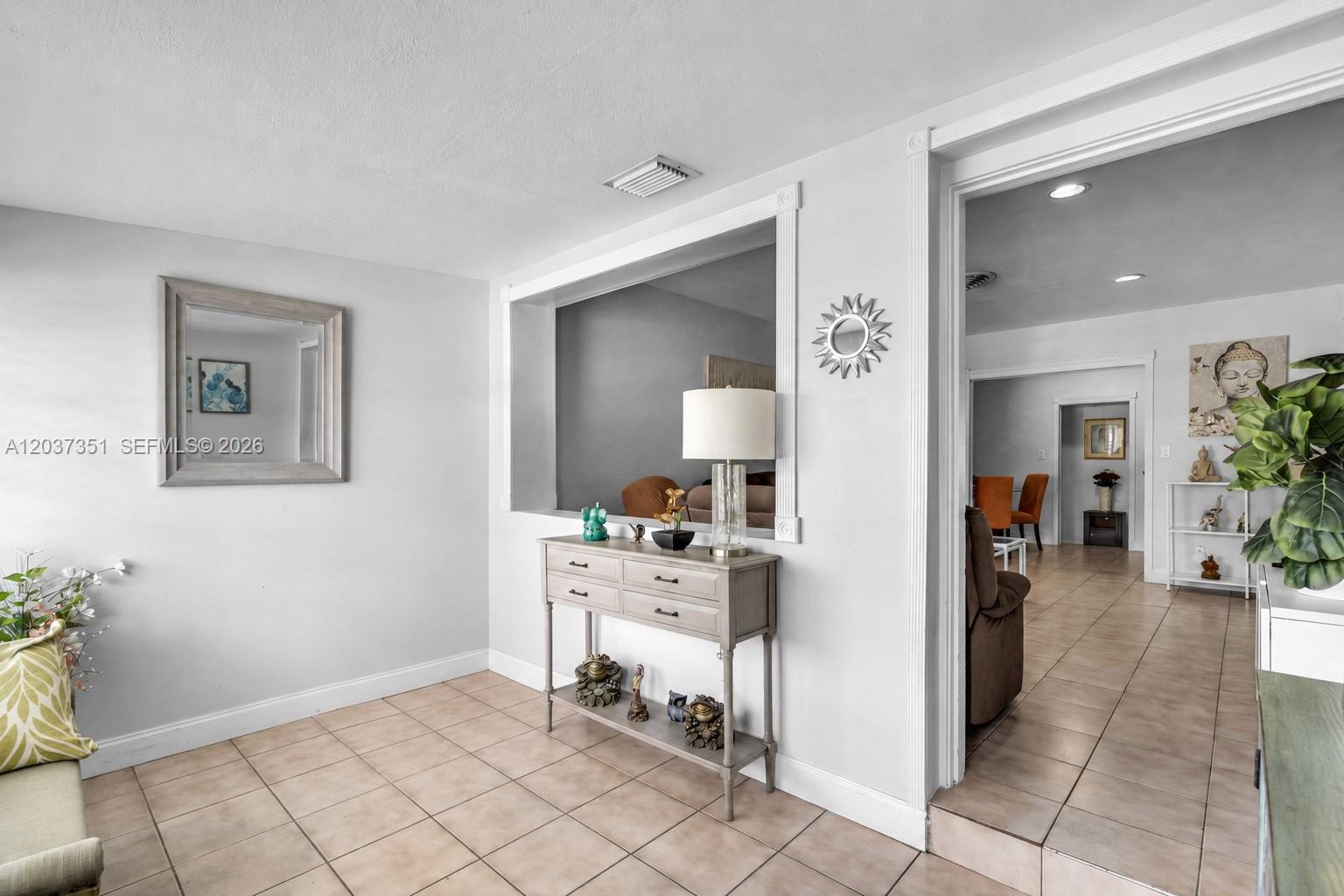 A living area features a pass-through window, a console table, and tile flooring — 2355 SW 1st St, Miami FL 33135, MIAMI, FL