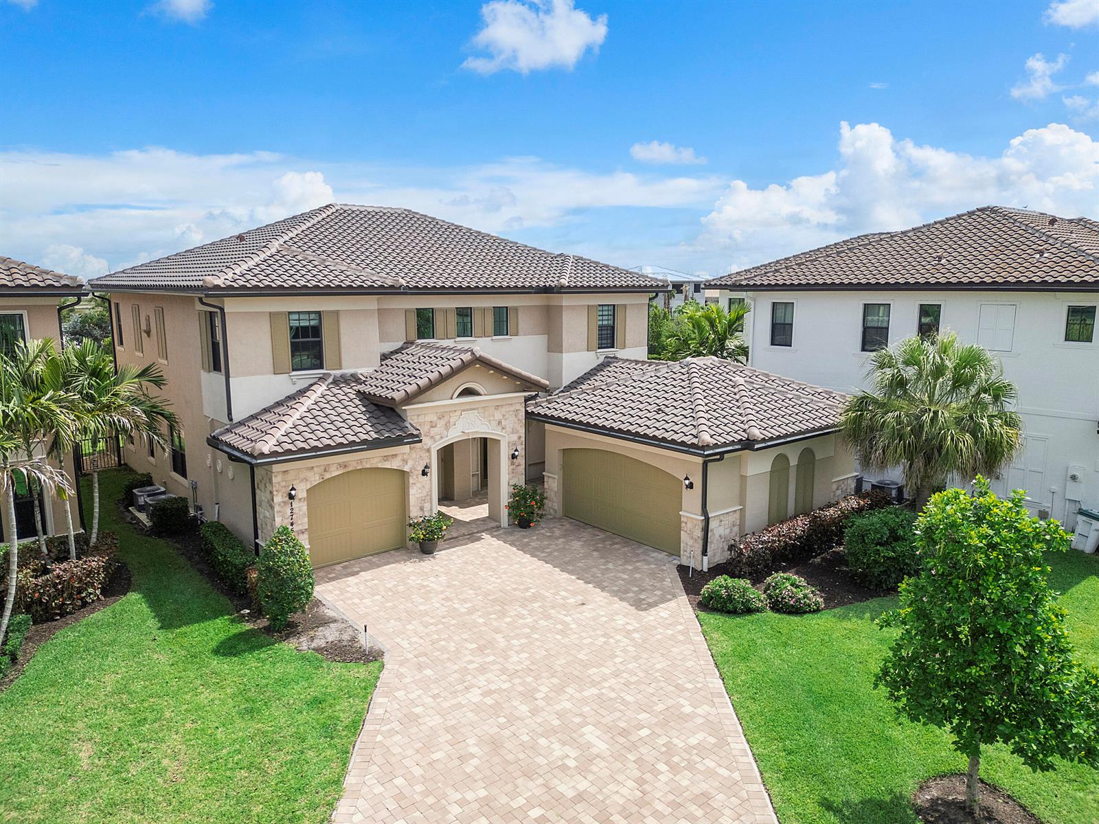 An aerial view of a two-story house with a tiled roof and paved driveway — 12745 Bayside Court, Parkland FL 33076, PARKLAND, FL
