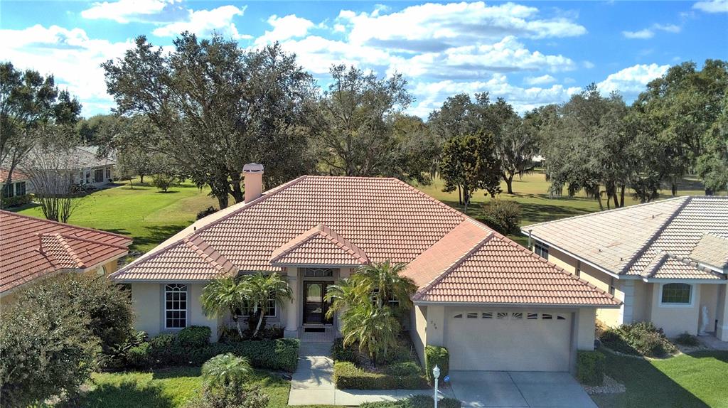 An aerial view of a single-story house with a tiled roof and attached garage — 239 GOLF AIRE BOULEVARD, WINTER HAVEN, FL