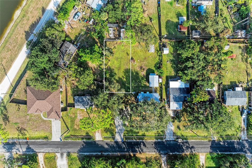 An aerial view shows a vacant rectangular lot outlined in white between two residential properties — 0 PARK ROAD, VENICE, FL