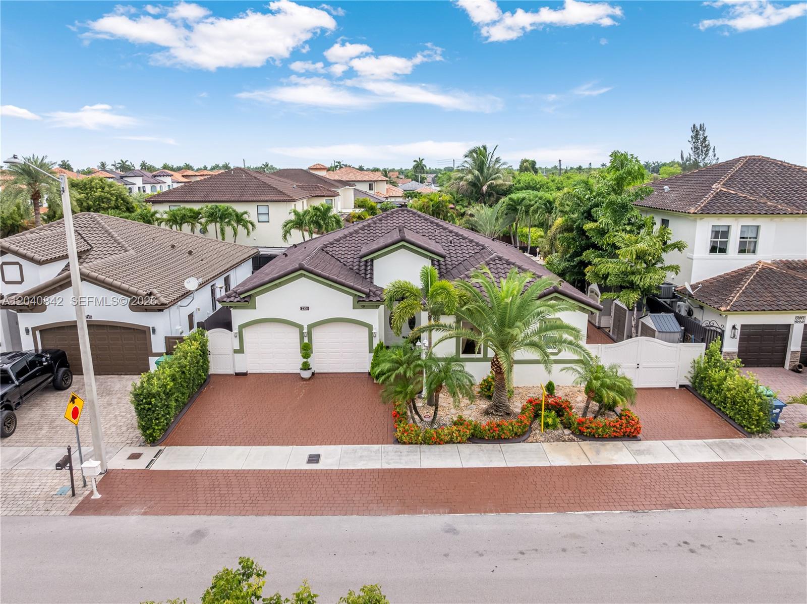 An aerial view shows a single-story house with a tiled roof, palm trees, and driveway — 2351 SW 145th Ave, Miami FL 33175, MIAMI, FL