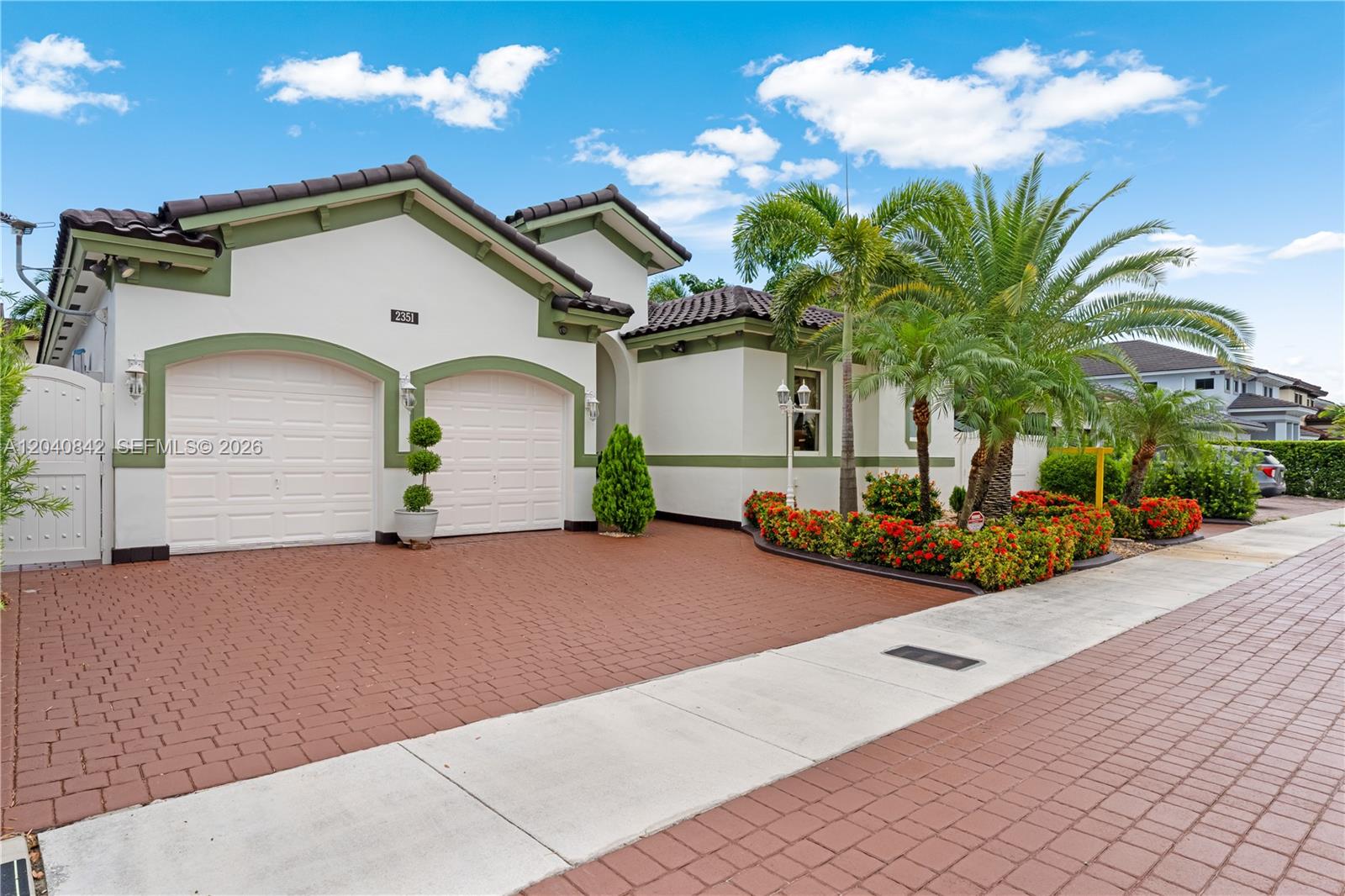 A single-story house with a two-car garage, red brick driveway, and palm trees — 2351 SW 145th Ave, Miami FL 33175, MIAMI, FL