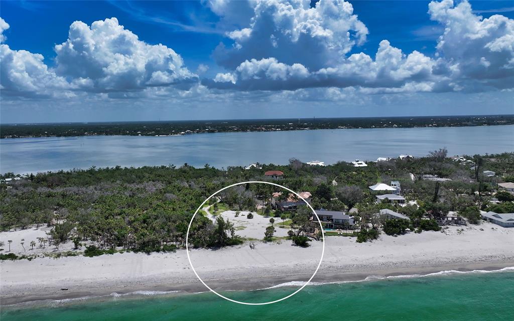 An aerial view of a sandy beach property with a house and surrounding vegetation — 6160 MANASOTA KEY ROAD, ENGLEWOOD, FL