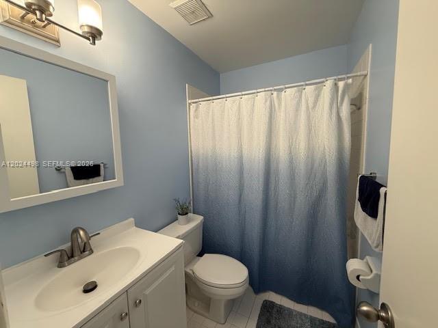 A bathroom features a white vanity, a blue-to-white ombre shower curtain, and light blue walls — 8911 SW 123rd Ct # 203, Miami FL 33186, MIAMI, FL