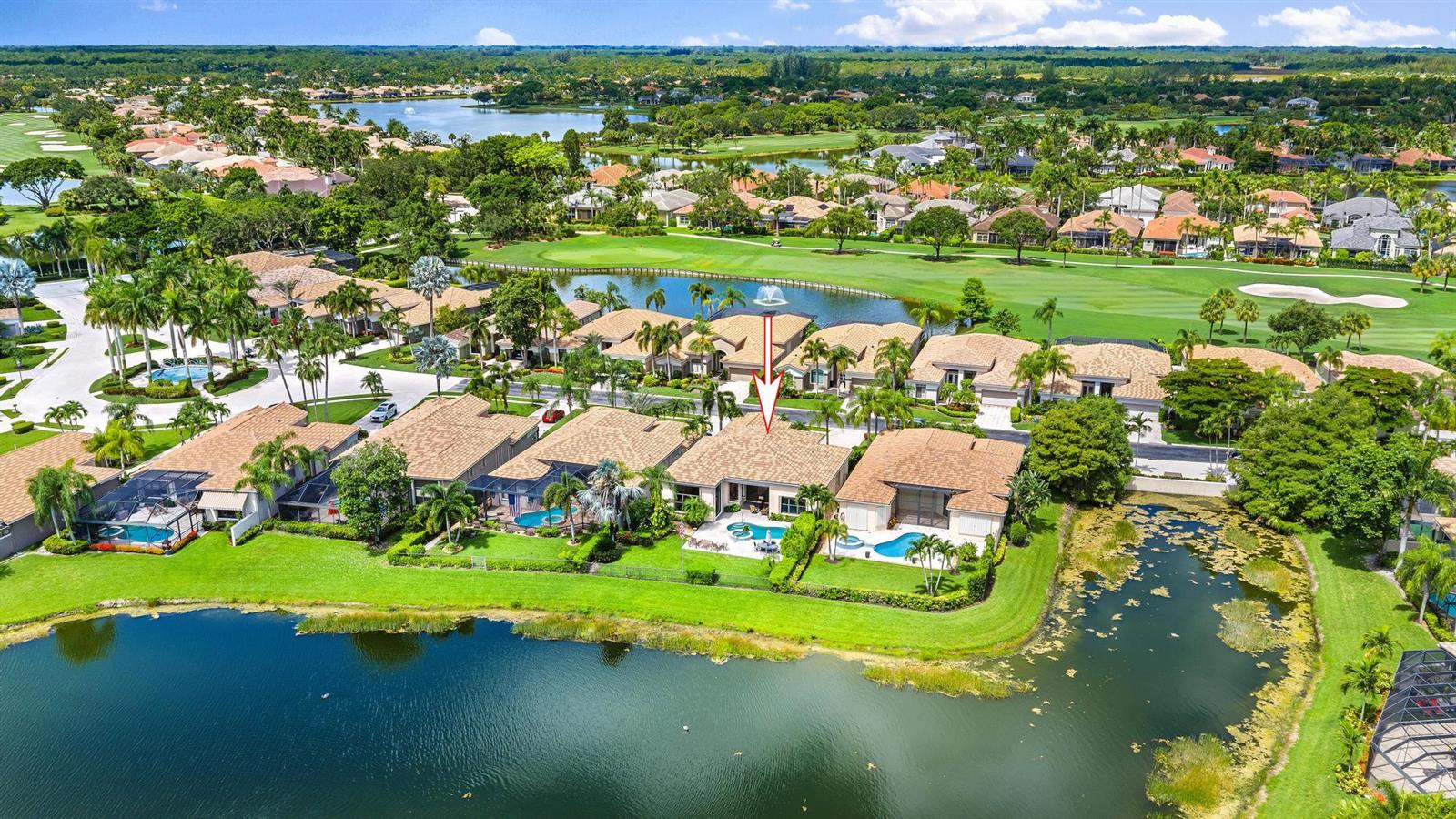 An aerial view of a residential neighborhood featuring homes with pools overlooking a golf course — 7510 Blue Heron Way, West Palm Beach FL 33412, WEST PALM BEACH, FL