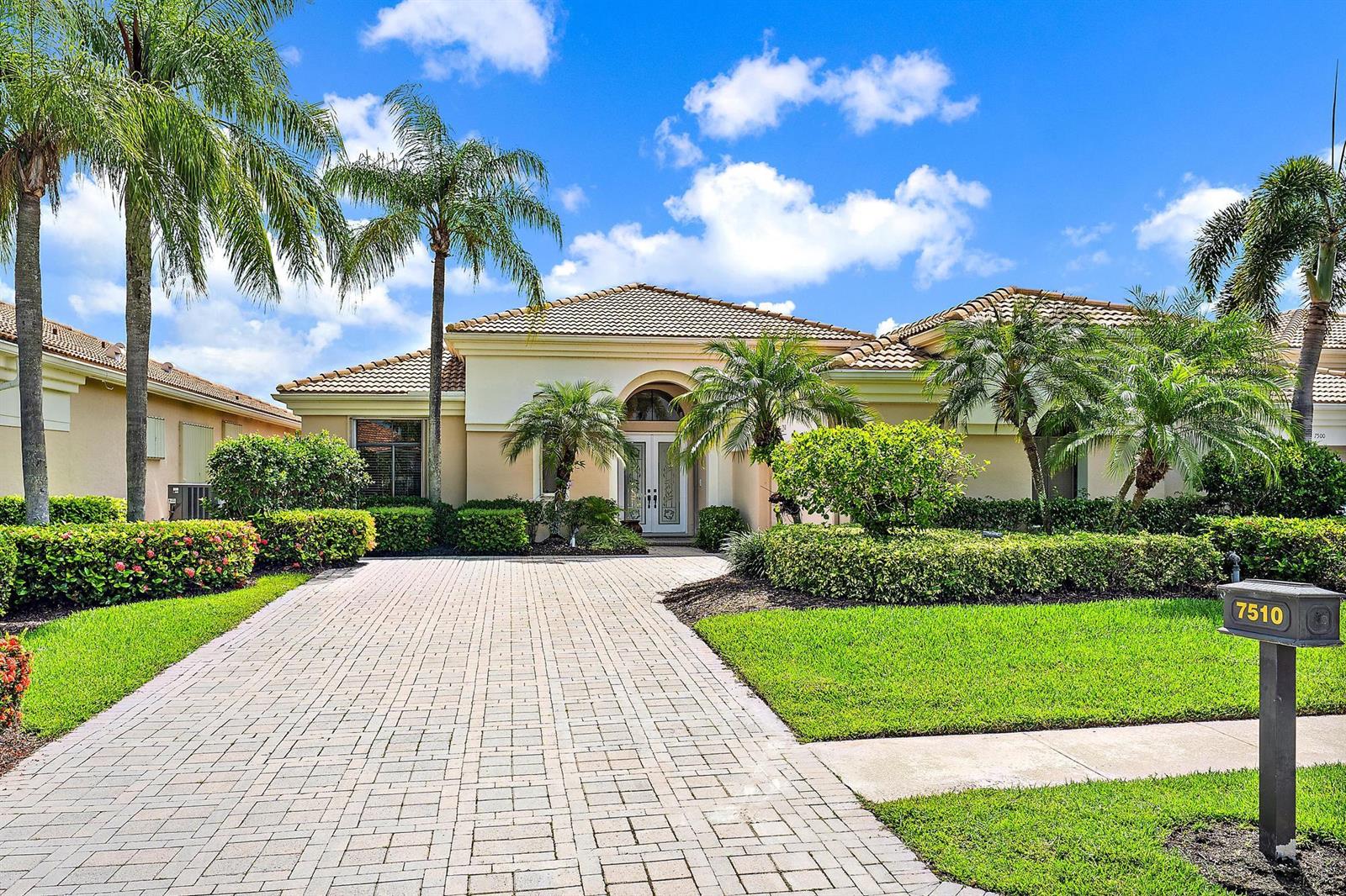 A single-story house with a paved driveway, palm trees, and a manicured lawn — 7510 Blue Heron Way, West Palm Beach FL 33412, WEST PALM BEACH, FL
