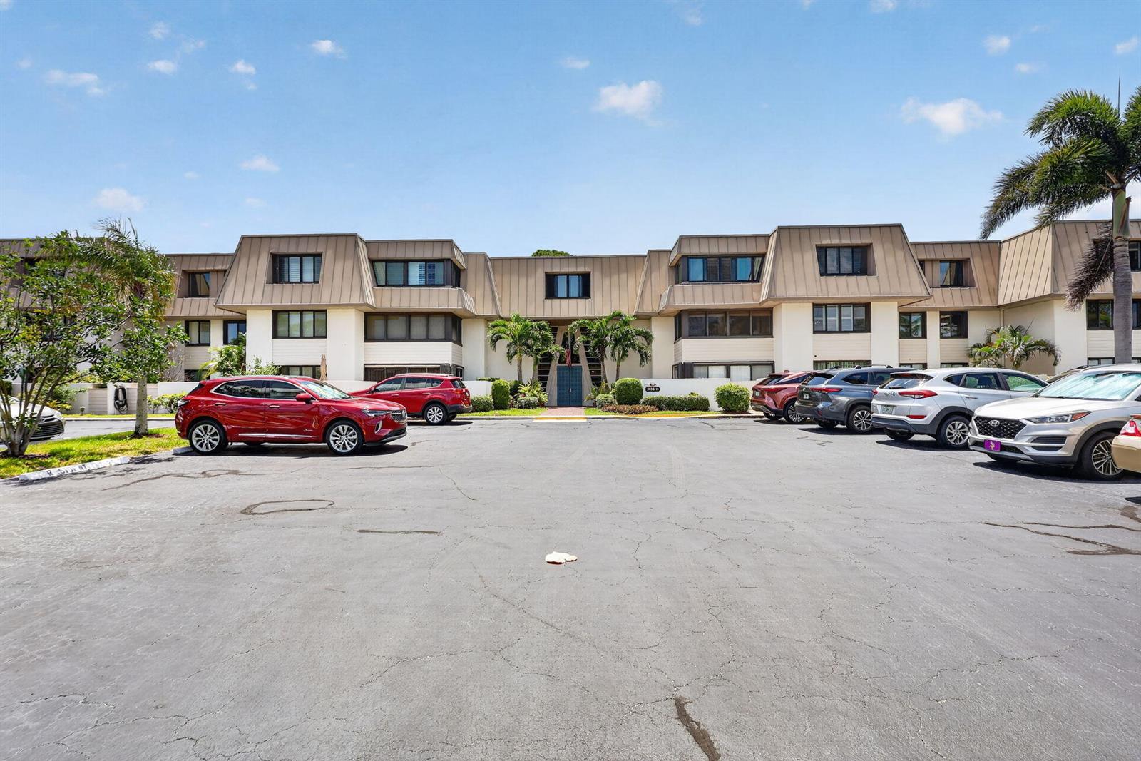 A multi-story apartment building with a parking lot in the foreground — 1800 SE Saint Lucie Boulevard # 203, Stuart FL 34996, STUART, FL